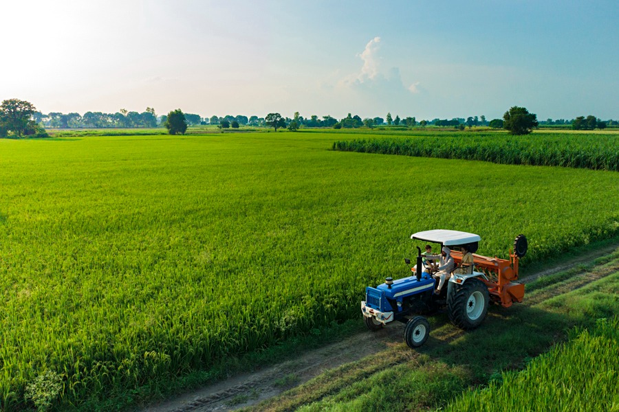 Tractor in lush green Indian farmland