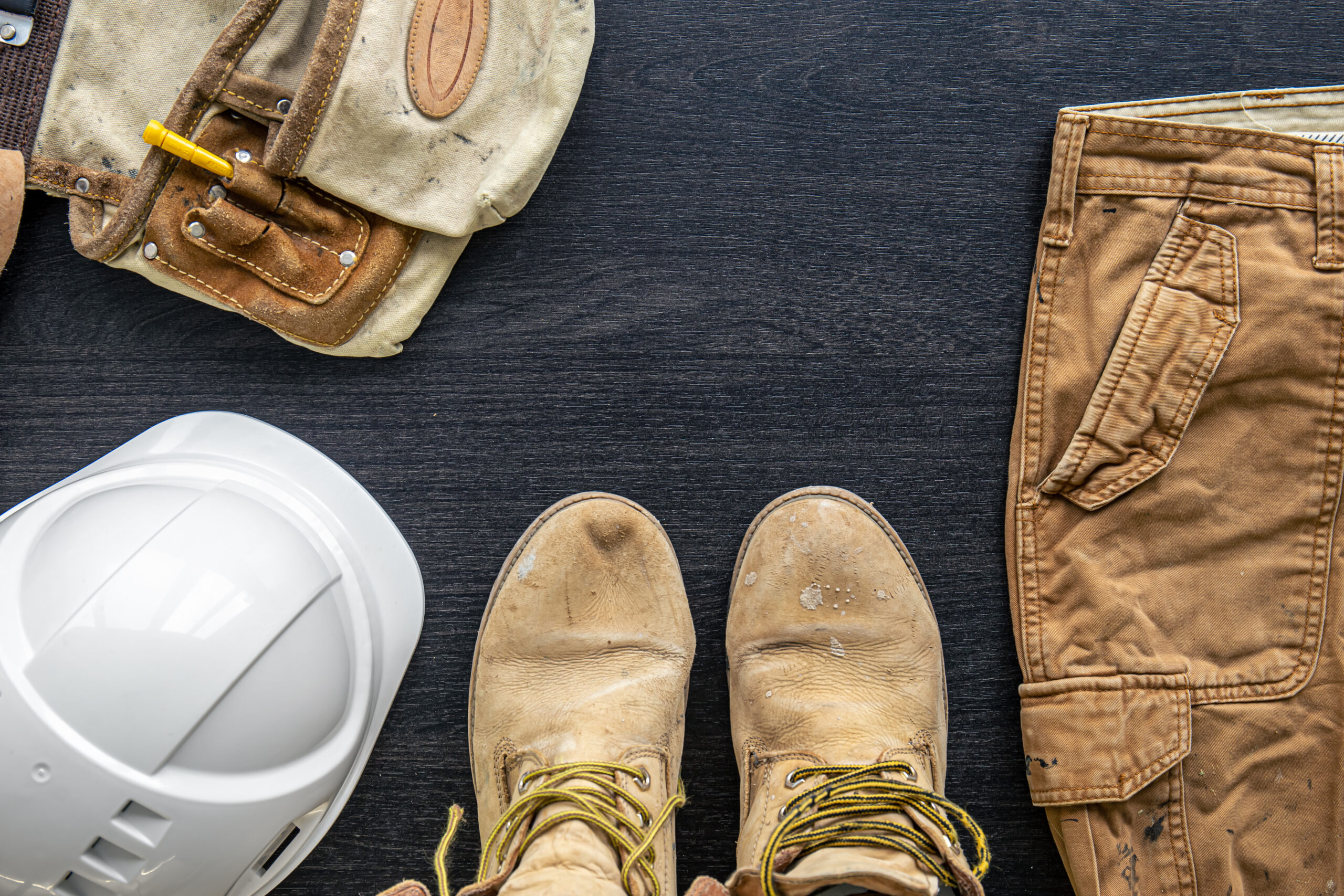 builder clothes, worker uniform on wooden background, flat lay.
