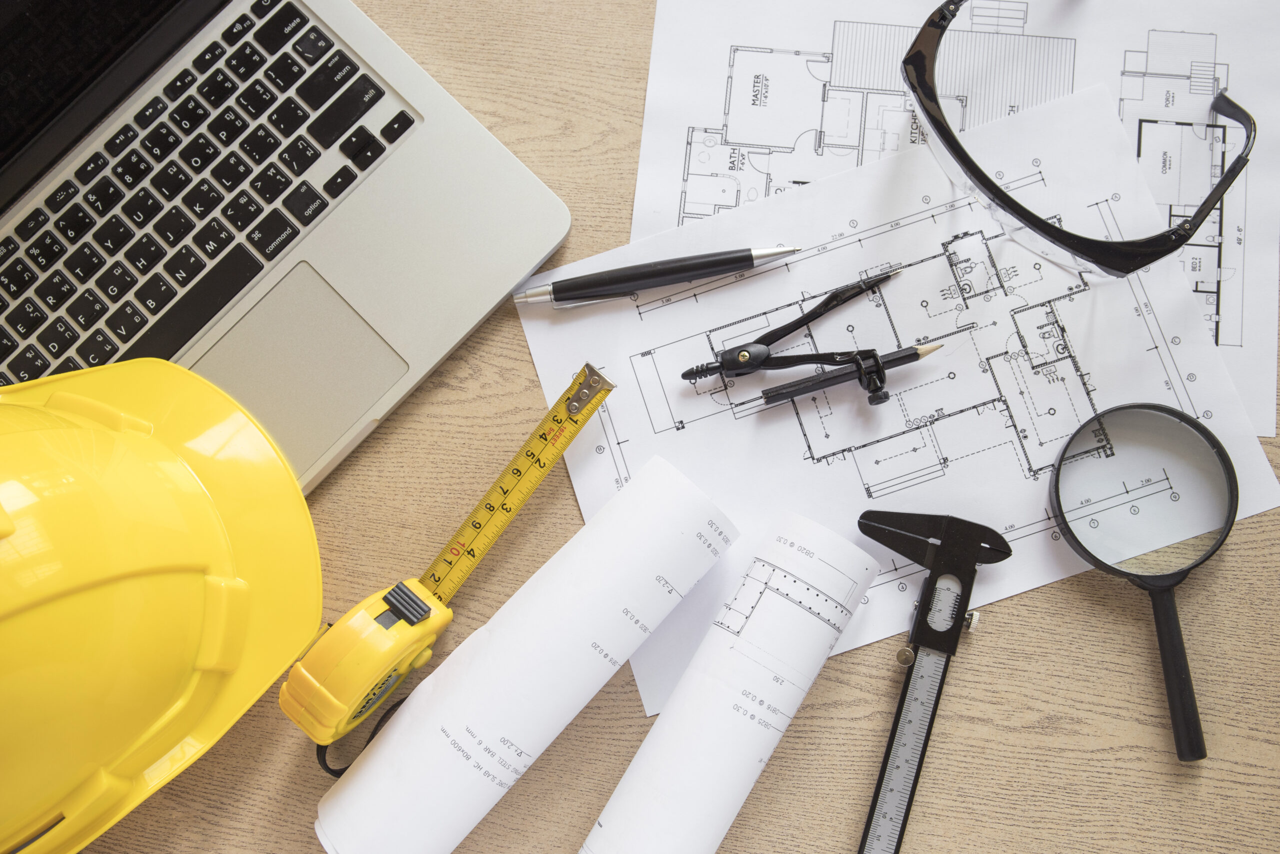 construction supplies drafts near laptop