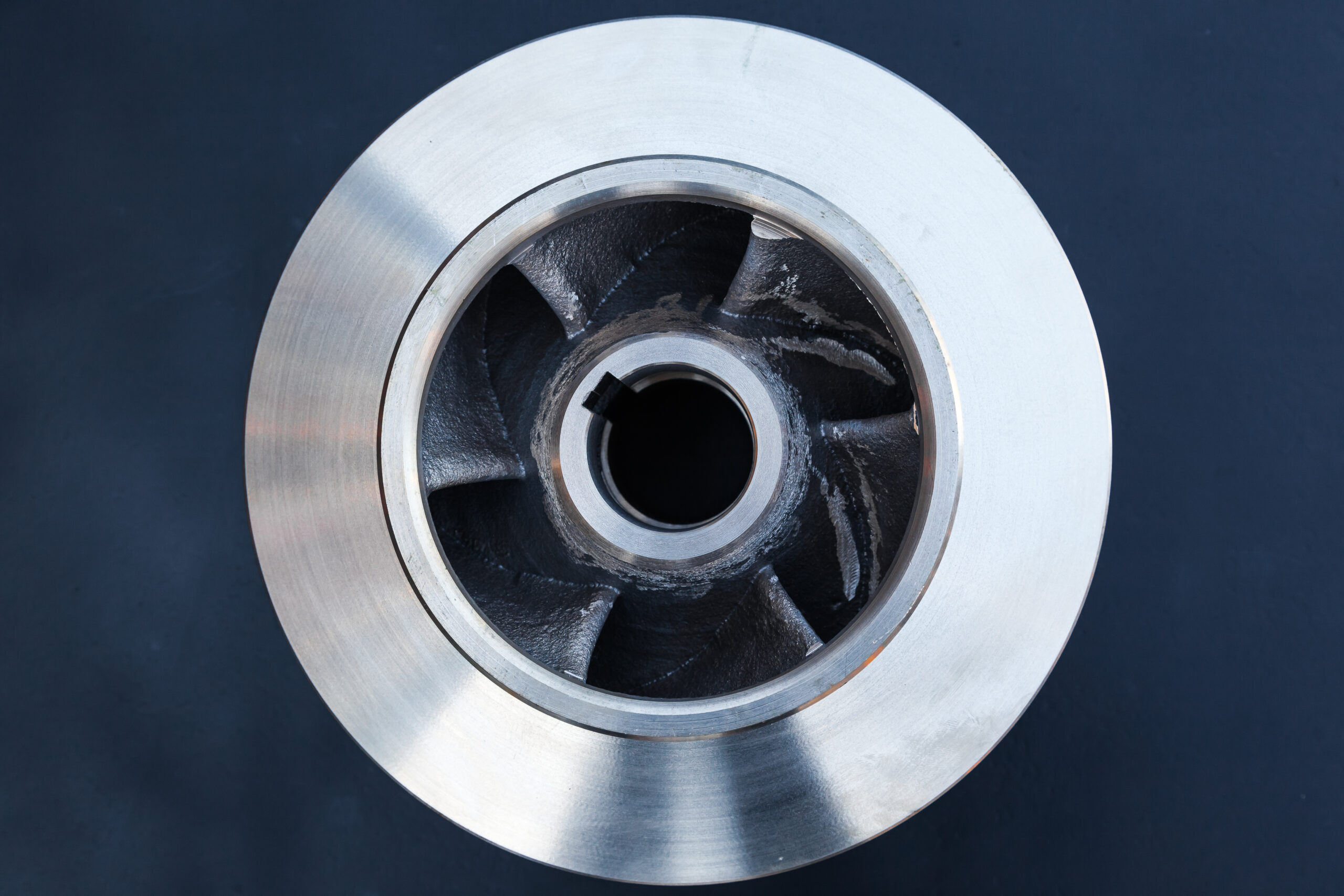 new bronze impeller on a dark blue background, top view.